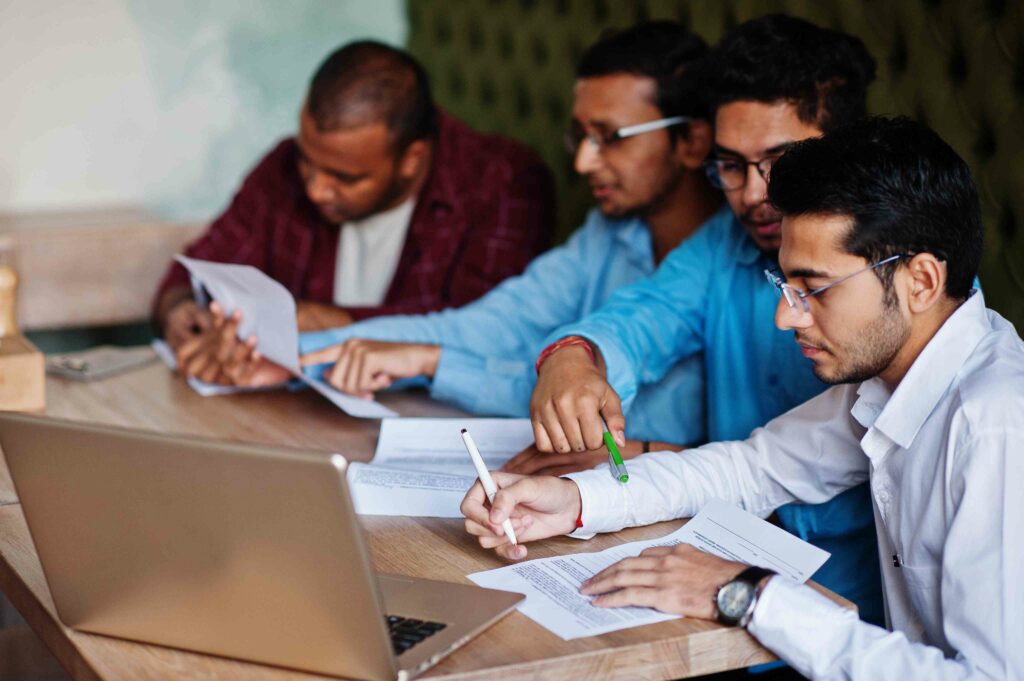 group-four-south-asian-men-s-posed-business-meeting-cafe-indians-together-sign-important-documents-contract-study-work-5
